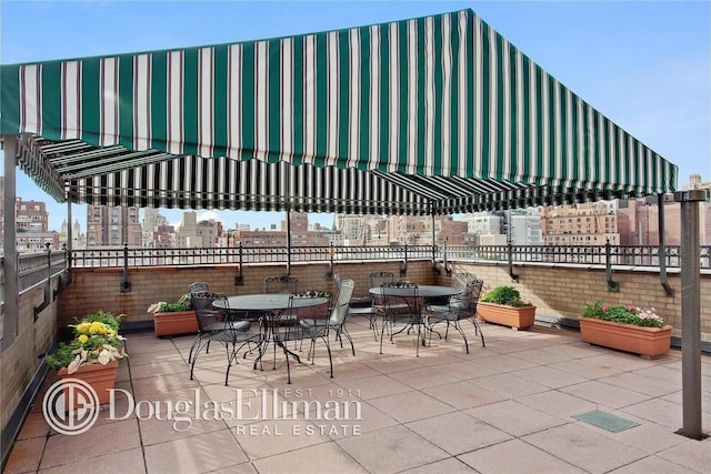 240 E 76th St Unit 14M, New York City, NY 10021 - view of patio / terrace with outdoor dining area, visible vents, and a city view