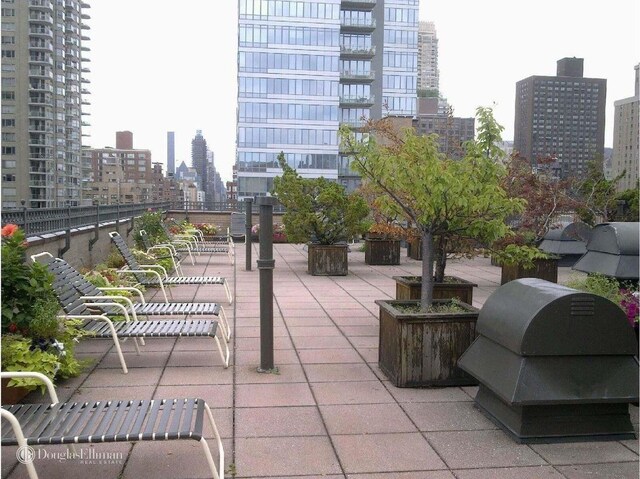 view of patio / terrace featuring a view of city and a grill