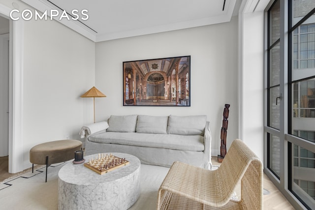 living room with floor to ceiling windows and ornamental molding