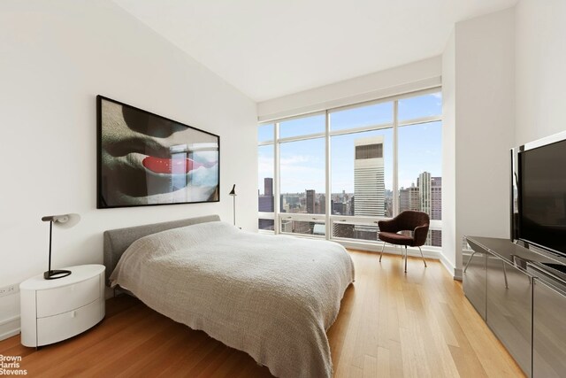 interior space with a tray ceiling and tile walls