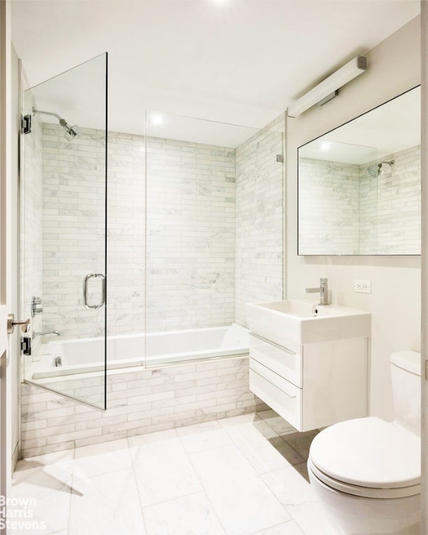 full bathroom featuring vanity, toilet, tile patterned floors, and tiled shower / bath combo