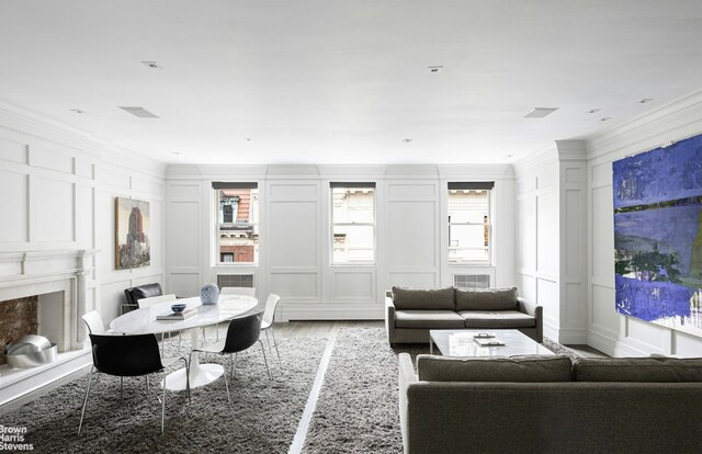 bedroom featuring hardwood / wood-style flooring, an AC wall unit, and ornamental molding