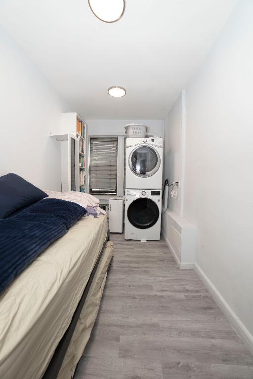 bedroom with cooling unit and wood-type flooring