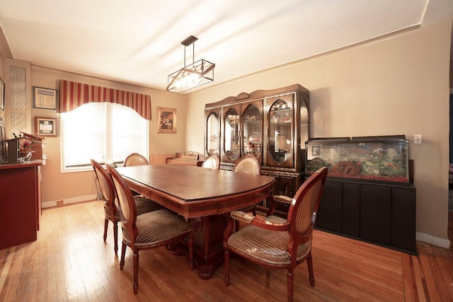 dining room with wood-type flooring