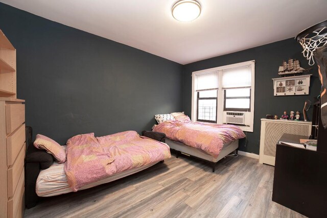 bedroom with wood-type flooring and ceiling fan