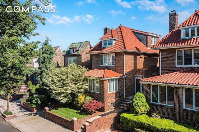 139 82nd St, New York City, NY 11209 - view of front of house featuring brick siding, a chimney, and a tiled roof