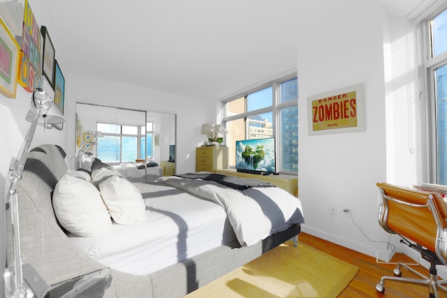 bedroom featuring baseboards and wood finished floors