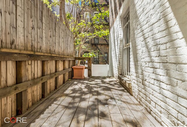 hallway with hardwood / wood-style floors and a textured ceiling