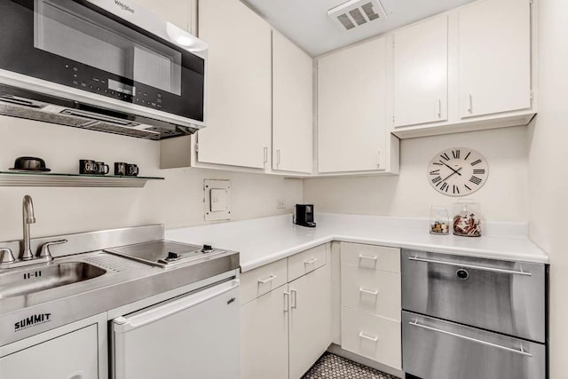 55 E 65th St Unit 7D, New York City, NY 10065 - kitchen featuring a sink, light countertops, white cabinets, and dishwasher