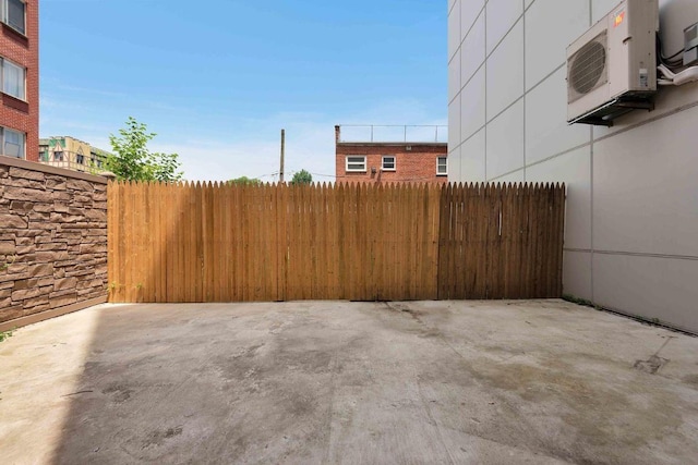 view of patio / terrace featuring ac unit and fence