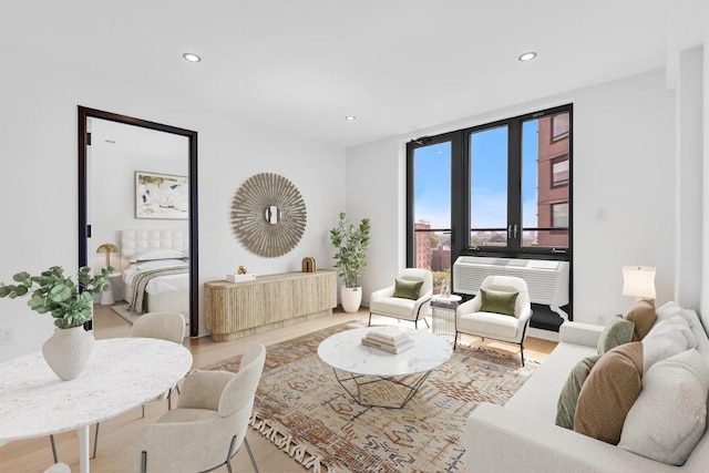 living area featuring a wall of windows, a wall unit AC, and recessed lighting