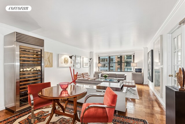 225 E 57th St Unit 7G, New York City, NY 10022 - dining room with beverage cooler, crown molding, and baseboards