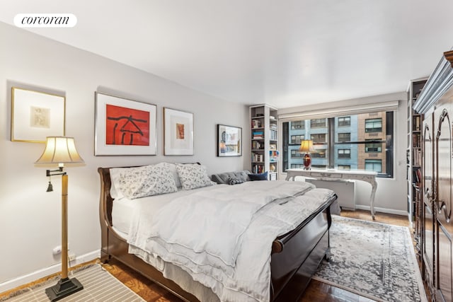 bedroom with dark hardwood / wood-style flooring