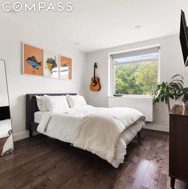 bedroom with dark wood-type flooring