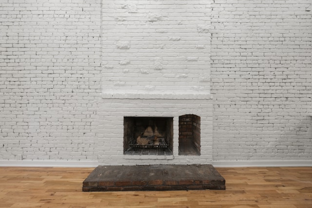 details with hardwood / wood-style flooring and a fireplace