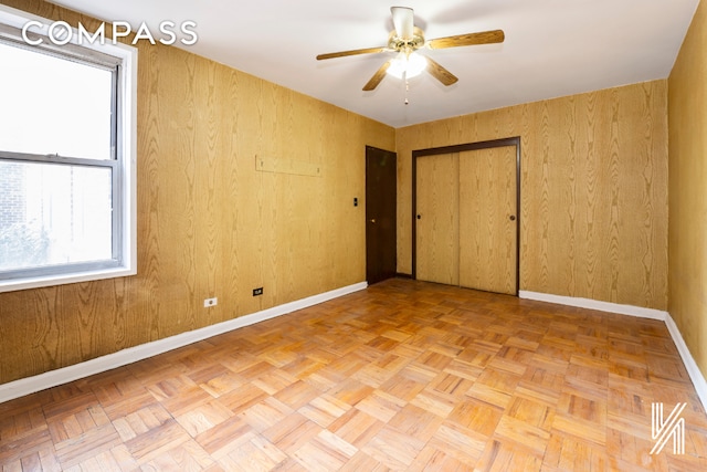 unfurnished bedroom with a ceiling fan and baseboards