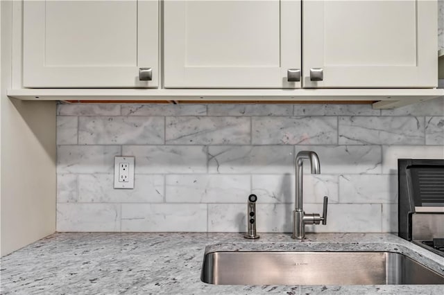 221 Mcdonald Ave Unit P3, New York City, NY 11218 - kitchen view of backsplash, white cabinetry, and light stone counters