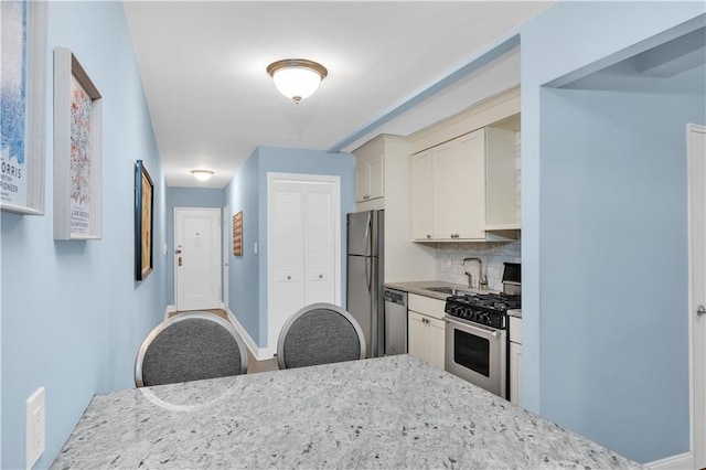 221 Mcdonald Ave Unit P3, New York City, NY 11218 - kitchen with stainless steel appliances, decorative backsplash, and light stone countertops