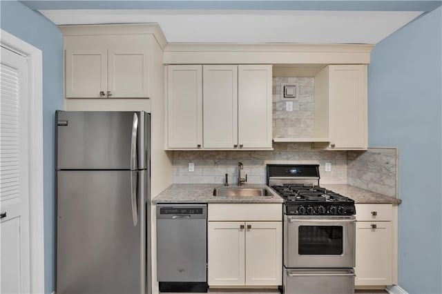 221 Mcdonald Ave Unit P3, New York City, NY 11218 - kitchen with appliances with stainless steel finishes, tasteful backsplash, light stone countertops, and white cabinetry