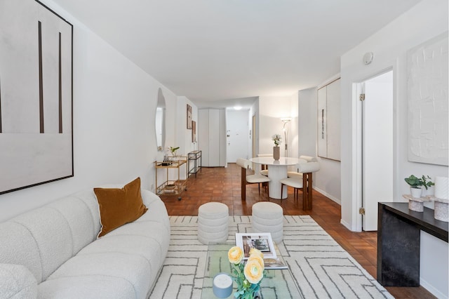 living area featuring baseboards