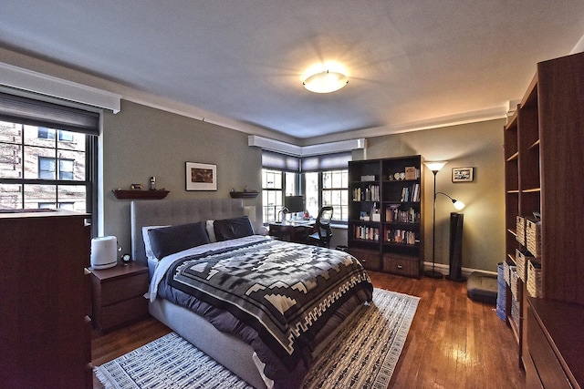 bedroom with baseboards and wood finished floors