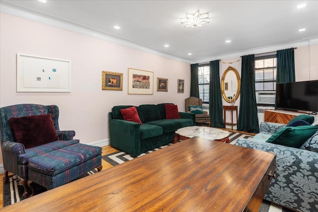 living room with crown molding and light wood-type flooring