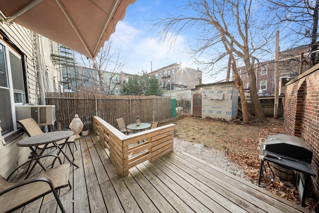 deck featuring a fenced backyard and grilling area