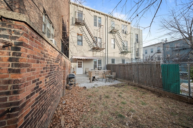 back of house featuring fence private yard and a patio