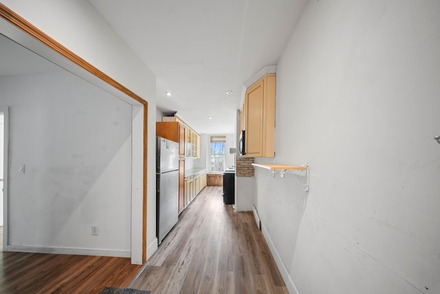 hallway with light wood-style floors and baseboards