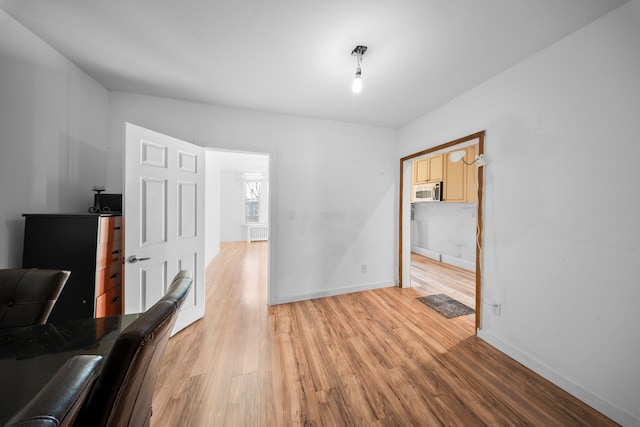 office featuring light wood-style flooring and baseboards