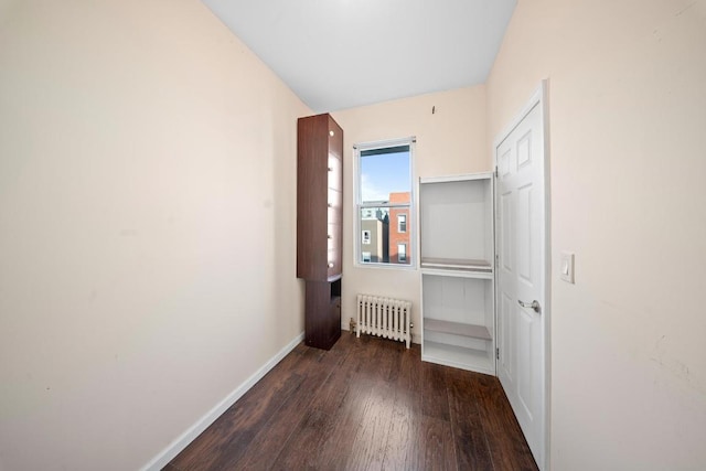 hall featuring dark hardwood / wood-style floors and radiator heating unit