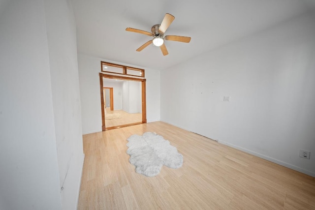 unfurnished room with light wood-type flooring and ceiling fan