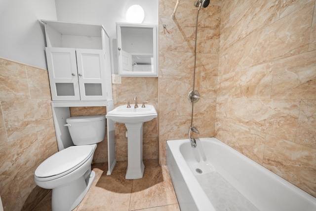 full bath featuring shower / bathtub combination, tile patterned flooring, toilet, a sink, and tile walls