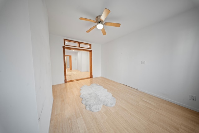 empty room with ceiling fan and wood finished floors