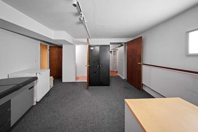 kitchen with track lighting and dark carpet