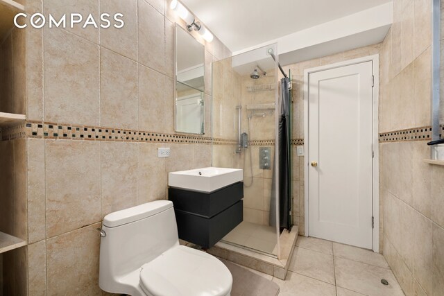 full bath featuring toilet, tile patterned flooring, vanity, a shower stall, and tile walls