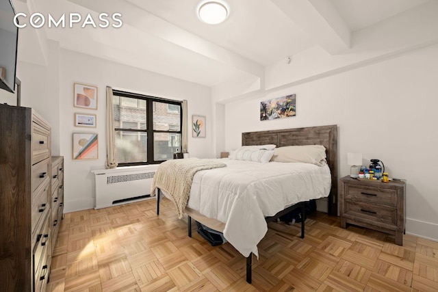 bedroom featuring radiator heating unit, beamed ceiling, and light parquet flooring