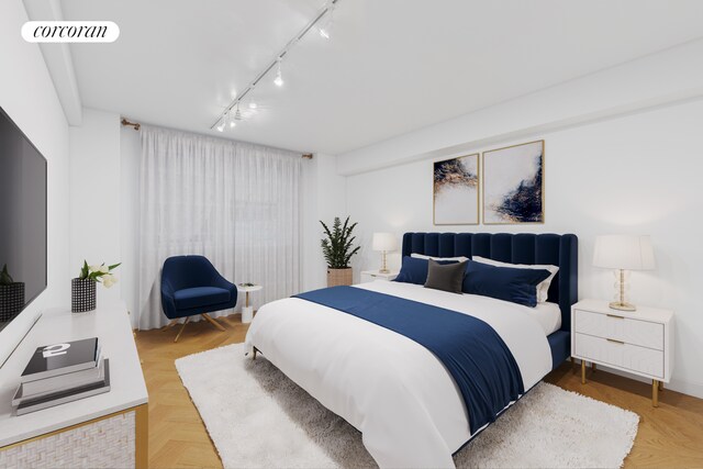 bedroom featuring parquet flooring and track lighting