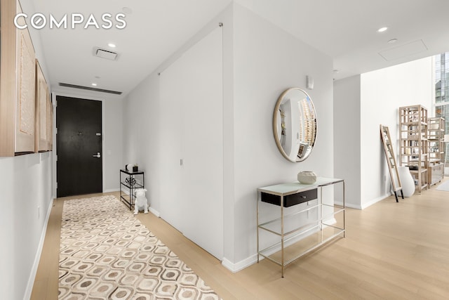 50 W St Unit 14B, New York City, NY 10006 - hallway featuring light wood-type flooring, recessed lighting, and baseboards