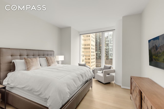 50 W St Unit 14B, New York City, NY 10006 - bedroom featuring light wood-style floors and baseboards