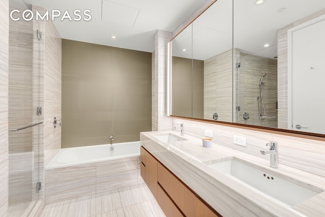 50 W St Unit 14B, New York City, NY 10006 - full bath with a stall shower, a garden tub, double vanity, tile patterned flooring, and recessed lighting