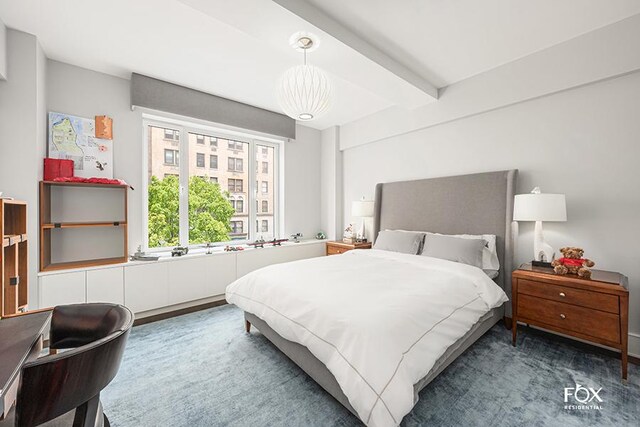 bedroom with a chandelier and beamed ceiling