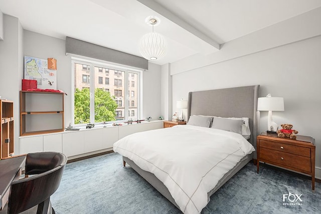 carpeted bedroom featuring beam ceiling