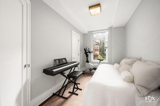 bedroom featuring wood finished floors and baseboards