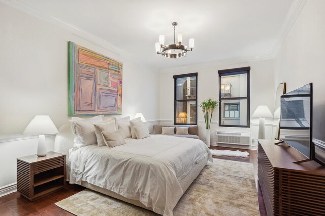 bedroom with a notable chandelier, ornamental molding, and a wall unit AC