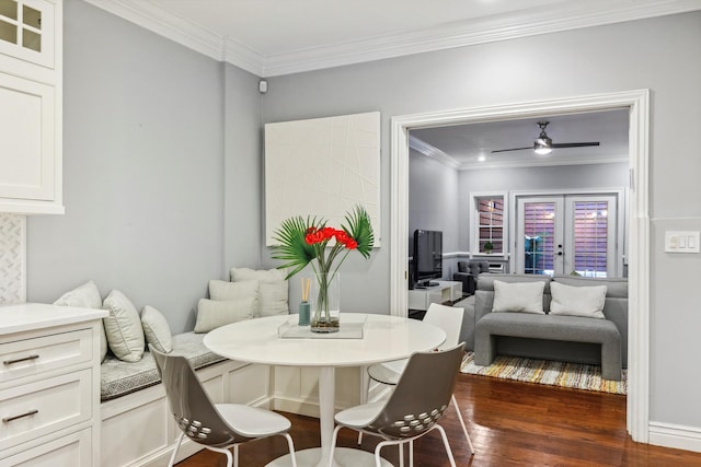 dining space with french doors, crown molding, a ceiling fan, and dark wood finished floors