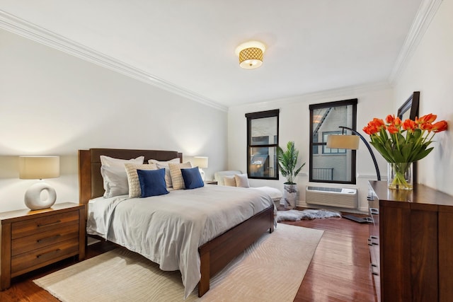 bedroom featuring ornamental molding, wood finished floors, and a wall mounted air conditioner