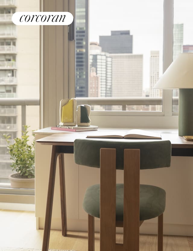 bar featuring a city view, plenty of natural light, and wood finished floors