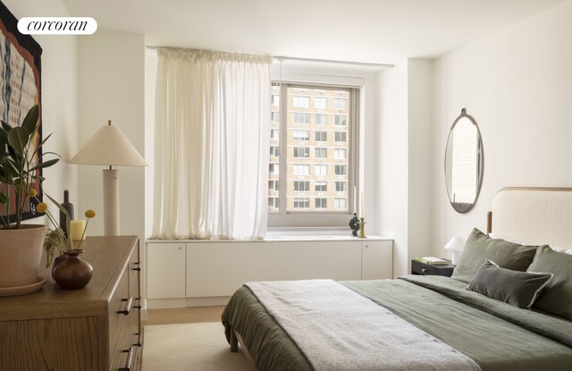 bedroom with visible vents and light wood-style flooring