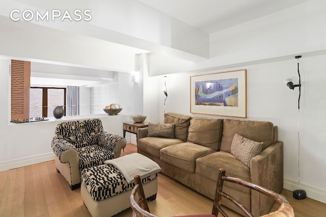 living room with light wood-type flooring and baseboards